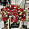 An exquisite composition of deep red blooms&mdash;roses, tulips, orchids, and dahlias&mdash;intertwined with