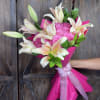 A 50 rose romantic bouquet featuring softly scented lilies paired with vibrant