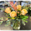 Beautiful peach roses, hypericum berries and waxflower.