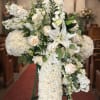 This elegant white cross standing spray is thoughtfully designed to express sympathy