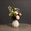 Cute pottery vase with a mix of ranunculus, delphinium, and solidago
Approximately 14"