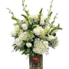 Elegant mixed premium white floral in a large cylinder vase.
