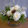 New beginnings deserve flowers! This all white arrangement includes roses, lisianthus, pine