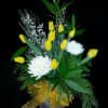 Lightly fragrant display of golden tulips and winter flowers with bay leaves