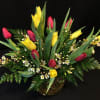 15 locally grown tulips mixed with a filler flower and fern. 