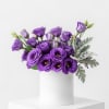 Purple lizianthus stylized and grouped in a white vessel. 