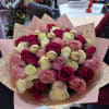 A bouquet of 40 roses, predominantly pink in various shades, subject to
