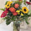 An interesting collection of bright color designed with greens. This arrangement will