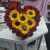 heart-shaped arrangement with red roses and sunflowers
