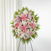 Artfully arranged pink and white florals create a captivating standing spray to