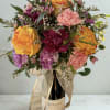 Bright array of flowers paired with a bottle of wine. Note that