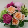 Peach "Tiffany" roses are combined with fuchsia and pink peonys, and bright