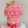 This breathtaking hatbox arrangement features 65 preserved pink roses, crowned with a