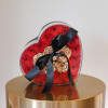 A romantic heart-shaped case filled with preserved red roses and accented with