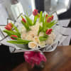This bouquet of roses and tulips is an elegant combination that unites