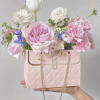 Fresh seasonal flowers in purse bouquet.