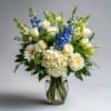 A fresh and timeless garden-style arrangement designed in a clear glass vase