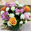 A spring colored bouquet of mini carnations, alstroemerias and roses in a