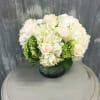 White and green arrangement of hydrangeas and roses perfect for a stylish