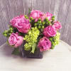 Simple cube vase of purple roses, mini green hydrangeas and hypericum, perfect
