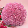 A lush hand-tied bouquet of fresh 100 cut pink roses with exposed