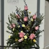 A sympathy pedestal arrangement offers a heartfelt expression of condolence, featuring a