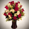 A striking modern floral arrangement featuring rich red roses paired with crisp