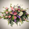 An elegant garden-style casket spray designed to convey peace, grace, and heartfelt