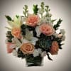A graceful and sophisticated floral arrangement showcasing blush peach roses paired with