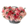A lush, garden-style flower basket in layered shades of soft blush +