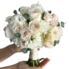 A romantic bridal bouquet in a soft ivory + blush palette with