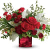 A love mix of red flowers in a red cube with a
