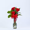 Three elegant red roses are beautifully accented with delicate white Monte Casino