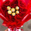 Romantic flower arrangement created with fresh 12 red roses and premium Ferrero