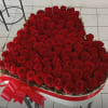 This breathtaking luxury 100 red roses arrangement features an abundant display of