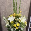 Stunning Gladiolas, lilies, larkspur, roses, alstroemerias, chrysanthemums, in a white basket vase.