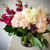 Welcome spring with this fresh combination of hydrangea, roses, stock, and rustic