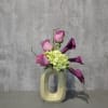 Our high style design of roses, miniature calla lilies and hydrangea in