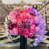 This beautiful arrangement is overflowing with roses, peonies, and orchids in different