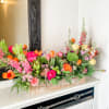 A variety of bright springy blooms perfect for a table centerpiece for