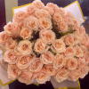 A classic bouquet of fresh cut garden roses, featuring a clean, elegant