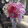 One of our most impressive arrangements! With cascading phalaenopsis orchids, roses, and