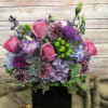 SLEEK MODERN ASSORTMENT WITH PURPLE AND BLUE HYDRANGEAS, BLUE TISSEL, LAVANDER ROSES.