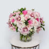 Our Pink Glamour arrangement is a stunning showcase of elegance, featuring lush