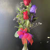 fresh purple and red roses in bud vase 