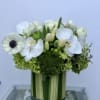 A fresh blend of white blooms set in lush green Hydrangea, with