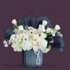 This striking black and white arrangement features a delicate mix of petite