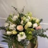 Delicate pastel florals arranged with care in a vase, creating a light