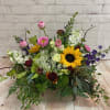 Box or cube  of many seasonal flowers, greens and fillers. This
