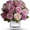 This tastefully terrific bouquet features soft pink and lavender roses in a